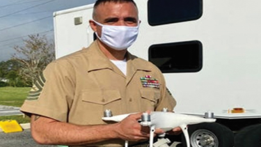 Master Sergeant Jonathan Oakley holding a drone